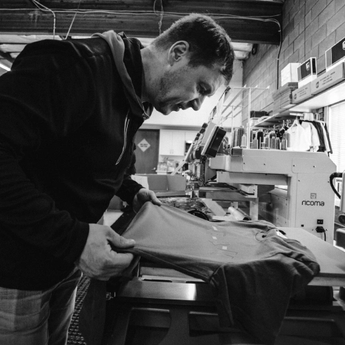 Employee loading a shirt onto the embroidery machine