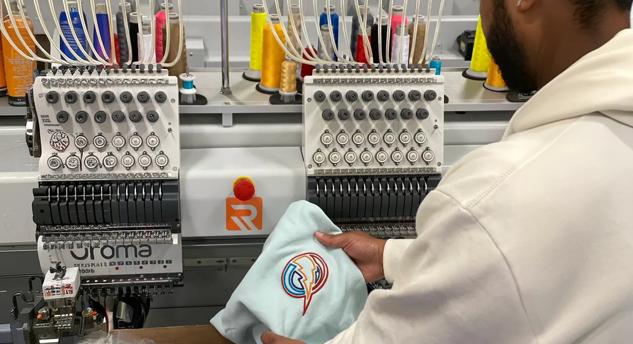 Embroidery machine stitching a logo